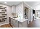 Kitchen wet bar area with ample storage, modern backsplash, and view into the living room at 3201 Lenox Ne Rd # 23, Atlanta, GA 30324