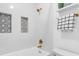 Bright bathroom showcases a white tub, patterned tile inlays and gold fixtures at 3201 Lenox Ne Rd # 23, Atlanta, GA 30324