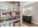 Stylish bathroom features a vanity with chevron patterned cabinet doors, gold hardware and an adjacent bookcase at 3201 Lenox Ne Rd # 23, Atlanta, GA 30324