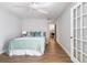 Cozy bedroom features hardwood flooring, a ceiling fan and a doorway to another room at 3201 Lenox Ne Rd # 23, Atlanta, GA 30324