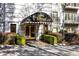 Front entrance to building features landscaping and black and gold awning at 3201 Lenox Ne Rd # 23, Atlanta, GA 30324