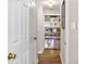 Hallway featuring built-in shelving with decor and hardwood floors at 3201 Lenox Ne Rd # 23, Atlanta, GA 30324