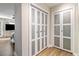 Bright hallway featuring hardwood floors and closet with modern white and glass doors at 3201 Lenox Ne Rd # 23, Atlanta, GA 30324