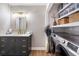 Well-organized laundry room features a sleek vanity, modern washer and dryer, and convenient built-in shelving at 3201 Lenox Ne Rd # 23, Atlanta, GA 30324