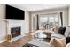 Bright living room featuring a fireplace, large TV, and comfortable sectional sofa near a table and chairs at 3201 Lenox Ne Rd # 23, Atlanta, GA 30324
