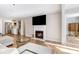Open-concept living room with a fireplace, large TV, sectional sofa, and view into the kitchen at 3201 Lenox Ne Rd # 23, Atlanta, GA 30324