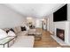 Open-concept living room with a fireplace, large TV, sectional sofa, and view into the kitchen at 3201 Lenox Ne Rd # 23, Atlanta, GA 30324