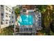 Aerial view of the community pool and lounge chairs surrounded by mature trees and residential buildings at 3201 Lenox Ne Rd # 23, Atlanta, GA 30324
