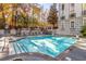 Outdoor pool is surrounded by lounge chairs and lush landscaping at 3201 Lenox Ne Rd # 23, Atlanta, GA 30324