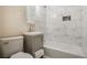 Well-lit bathroom featuring tiled shower-tub combo, modern vanity, and updated fixtures at 1256 Elizabeth Sw Ave, Atlanta, GA 30310