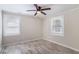 Bright bedroom with wood-look floors, a ceiling fan, and large windows at 1256 Elizabeth Sw Ave, Atlanta, GA 30310