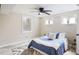 Cozy bedroom with neutral walls, wood-look floors, a ceiling fan, and two windows providing natural light at 1256 Elizabeth Sw Ave, Atlanta, GA 30310