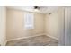 Cozy bedroom featuring a ceiling fan, a large window, and light-colored walls and flooring at 1256 Elizabeth Sw Ave, Atlanta, GA 30310