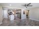 Modern kitchen with stainless steel appliances, white cabinetry, and an island, seamlessly flowing into an open-concept living space at 1256 Elizabeth Sw Ave, Atlanta, GA 30310