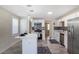 Stylish kitchen with white cabinets, stainless steel appliances, island with pendant lights, and contrasting backsplash at 1256 Elizabeth Sw Ave, Atlanta, GA 30310