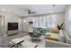 Staged living room with furniture, large windows, wood-look floors, neutral walls, and ceiling fan at 1256 Elizabeth Sw Ave, Atlanta, GA 30310