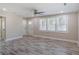 Bright living room with large windows, wood-look floors, neutral walls, and ceiling fan at 1256 Elizabeth Sw Ave, Atlanta, GA 30310