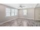 Light-filled living room with wood-look floors, neutral walls, and windows offering views of the outdoors at 1256 Elizabeth Sw Ave, Atlanta, GA 30310