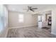 Bright living room with large windows, wood-look floors, neutral walls, and modern kitchen in background at 1256 Elizabeth Sw Ave, Atlanta, GA 30310