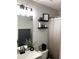 Bathroom showcasing modern fixtures, floating shelves with decorative items and framed art at 2546 Tullamore Cir, Snellville, GA 30039