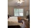 Well-lit bedroom with a vaulted ceiling, a ceiling fan, and a large window with natural light at 2546 Tullamore Cir, Snellville, GA 30039