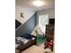 Stylishly decorated bedroom featuring a play teepee, modern wall decor, and a bed with colorful bedding at 2546 Tullamore Cir, Snellville, GA 30039