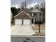 Charming two-story home with a brick front, a two-car garage, and well-maintained landscaping at 2546 Tullamore Cir, Snellville, GA 30039