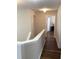 Upstairs hallway with wood floors leading to bedrooms at 2546 Tullamore Cir, Snellville, GA 30039