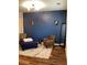 Stylish living room with hardwood floors, blue accent wall, and comfortable seating at 2546 Tullamore Cir, Snellville, GA 30039