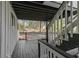 Back porch featuring white railing, wooden stairs, and a view of the lush green forest at 353 Colchester Dr, Stone Mountain, GA 30088