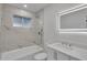 Modern bathroom with marble tile, shower, and illuminated mirror at 353 Colchester Dr, Stone Mountain, GA 30088