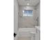 Modern bathroom with tub, shower, and marble tile at 353 Colchester Dr, Stone Mountain, GA 30088