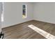 Sun-drenched bedroom with neutral walls, wood-look floors, and two windows creating a bright and inviting space at 353 Colchester Dr, Stone Mountain, GA 30088