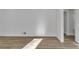 Clean bedroom with pristine white walls, wood floors, base trim, and an interior door at 353 Colchester Dr, Stone Mountain, GA 30088