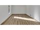 Bright bedroom with wood-look flooring and a window for natural light; a serene and modern space at 353 Colchester Dr, Stone Mountain, GA 30088