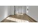 Bright bedroom with wood-look flooring and white walls offering modern style and natural light at 353 Colchester Dr, Stone Mountain, GA 30088