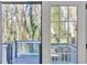 A view of an exterior deck from inside the home featuring neutral paint and natural light at 353 Colchester Dr, Stone Mountain, GA 30088