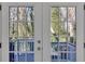A view through french doors leading to a deck with neutral paint and natural light at 353 Colchester Dr, Stone Mountain, GA 30088