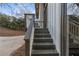 A view of the entryway steps leading to the house featuring neutral paint and a modern glass door at 353 Colchester Dr, Stone Mountain, GA 30088