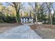 Charming two-story home featuring a carport, manicured landscaping, and a freshly painted exterior at 353 Colchester Dr, Stone Mountain, GA 30088