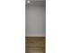Narrow hallway with wood-look flooring and neutral paint offers a simple passageway through the home at 353 Colchester Dr, Stone Mountain, GA 30088
