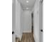 Neutral hallway features wood-look floors and white trim, seamlessly connecting different areas of the home at 353 Colchester Dr, Stone Mountain, GA 30088