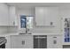 Bright kitchen featuring white cabinets, stainless steel appliances, and a view from over the sink at 353 Colchester Dr, Stone Mountain, GA 30088