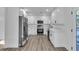 Modern white kitchen with stainless steel appliances, sleek cabinetry, and durable countertop at 353 Colchester Dr, Stone Mountain, GA 30088