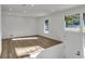 Bright living room with wood-look floors and a large window to the front yard providing ample natural light at 353 Colchester Dr, Stone Mountain, GA 30088