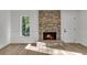 Cozy living room features a brick fireplace with an inviting ambiance, along with white trim and wood-look flooring at 353 Colchester Dr, Stone Mountain, GA 30088