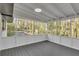 Enclosed porch with gray flooring, a white railing, and bright light at 353 Colchester Dr, Stone Mountain, GA 30088