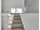 Bright interior staircase featuring wood-look treads, white risers and walls, and natural light at 353 Colchester Dr, Stone Mountain, GA 30088