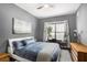 A cozy bedroom features grey walls, a ceiling fan, a window, and stylish decorations at 870 Inman Village Ne Pkwy # 222, Atlanta, GA 30307