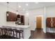 A stylish kitchen with dark wood floors, barstool seating, and modern stainless steel appliances at 870 Inman Village Ne Pkwy # 222, Atlanta, GA 30307